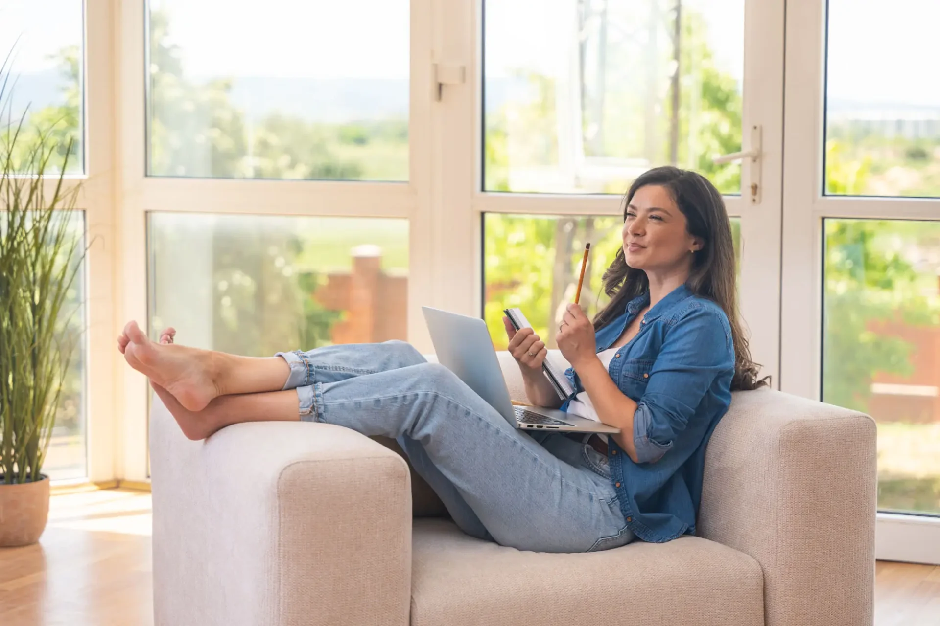 Woman video chatting on a tablet in a cozy living room.