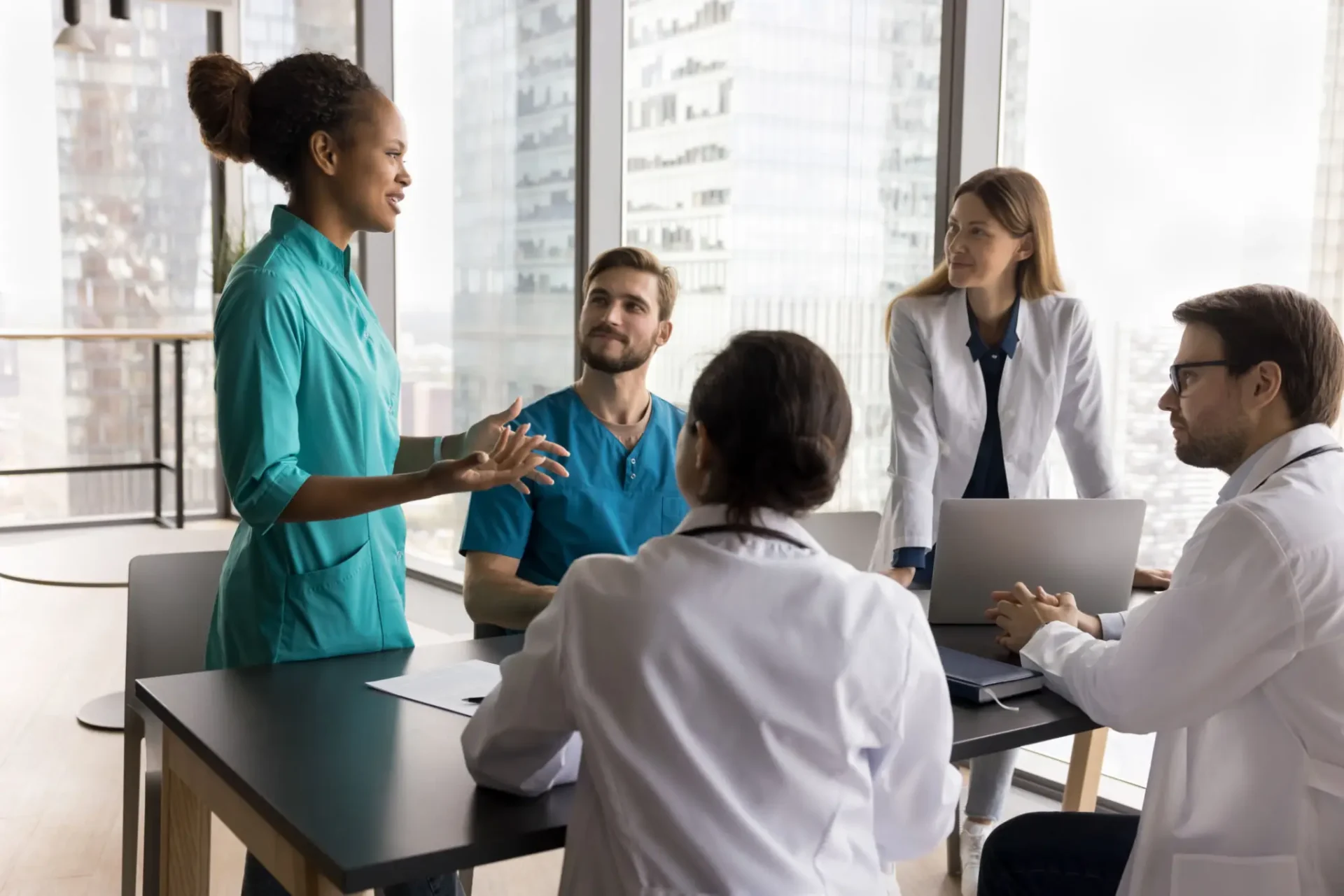 Healthcare professionals discussing patient care in a meeting room.
